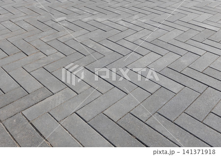 Herringbone pattern of gray concrete pavers, urban background Herringbone pattern of gray concrete pavers, urban background 141371918