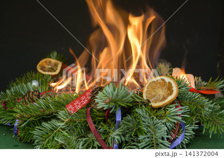 High open flames rapidly destroy a Christmas wreath, creating an extremely dangerous indoor fire situation. High open flames rapidly destroy a Christmas wreath, creating an extremely dangerous indoor fire situation. 141372004