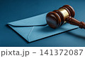 A judge's mallet made of wood, placed firmly on an unopened, officially sealed letter 141372087