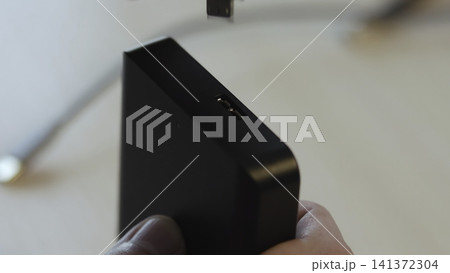 Close Examination Of Connecting Usb Cable Into Black Power Adapter With Focus On Proper Fitting . Media Close Examination Of Connecting Usb Cable Into Black Power Adapter With Focus On Proper Fitting . Media 141372304