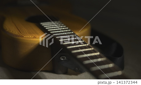 Warm close-up of acoustic guitar neck 141372344