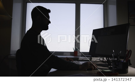 Person Working Diligently. Male Professional Typing On Keyboard Amidst Organized Workspace Environment. Media Person Working Diligently. Male Professional Typing On Keyboard Amidst Organized Workspace Environment. Media 141372347