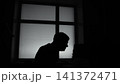 Creative Director Contemplates Behind Window. Silhouette Of Man Staring Through Glass Panel . Media 141372471