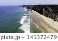 Sea Cliffs Sparkle. Vast Ocean Meets Rugged Shoreline. Bright Sunlight Highlights Shimmering Ocean Waves . Media 141372479