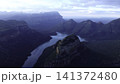 Dawn Over Rugged Cliffs And Flowing Waters. Majestic Canyon River With Mist And Golden Sunlight At Dawn . Media 141372480