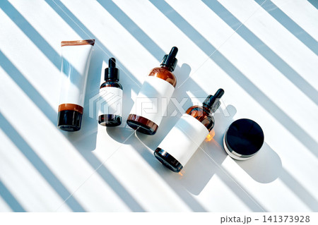 Natural skincare cosmetic bottles and serum products with sunlight Natural skincare cosmetic bottles and serum products with sunlight 141373928