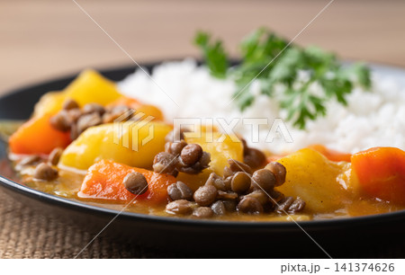 Japanese curry with lentil, carrot, potato and onion eating with cooked rice, Vegetarian food Japanese curry with lentil, carrot, potato and onion eating with cooked rice, Vegetarian food 141374626