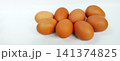 A group of fresh brown chicken eggs against a white background. 141374825