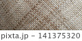 A background featuring the intricate texture of a hand-woven palm leaf mat. 141375320