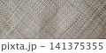 Hand-woven straw mat texture with a diagonal accent pattern. 141375355