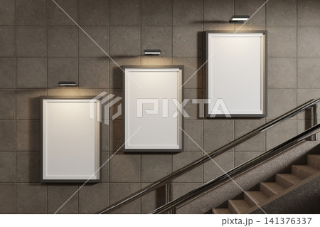Three vertical frame mockups on wall next to staircase 141376337