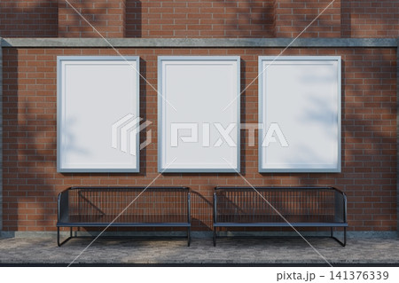 Three blank vertical poster frames mockup on brick wall 141376339