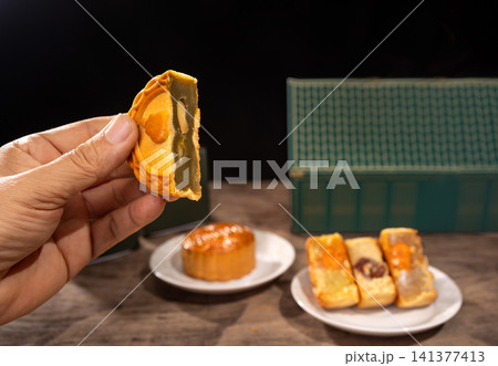 Traditional Mooncakes for Mid-Autumn Festival Celebration on Dark Background. Traditional Mooncakes for Mid-Autumn Festival Celebration on Dark Background. 141377413