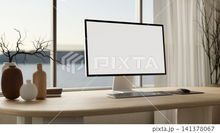 Minimalist home office desk with blank computer screen and sea view. 141378067