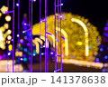 Purple LED light curtain in foreground with golden yellow tunnel bokeh background. Winter illumination festival night scene decoration 141378638