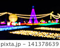 Christmas tree and garden decoration with beautiful bokeh lighting at night. Outdoor winter illumination festival event landscape display 141378639