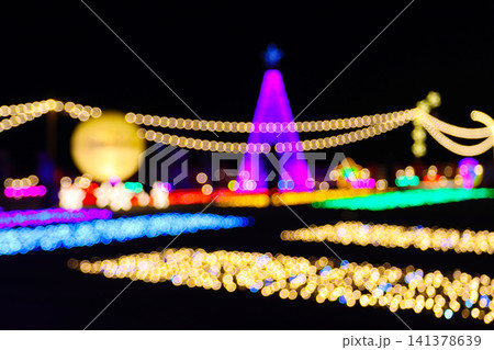 Christmas tree and garden decoration with beautiful bokeh lighting at night. Outdoor winter illumination festival event landscape display 141378639