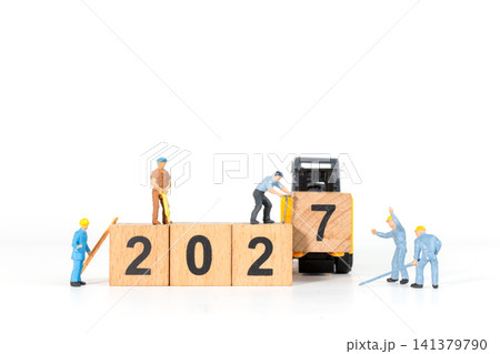Miniature Construction Workers and Forklift Building 2027 New Year Wooden Block Concept Miniature Construction Workers and Forklift Building 2027 New Year Wooden Block Concept 141379790