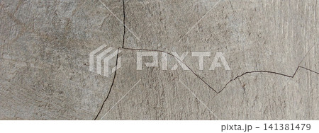 Jagged cracks on the rough surface of the concrete wall. Jagged cracks on the rough surface of the concrete wall. 141381479