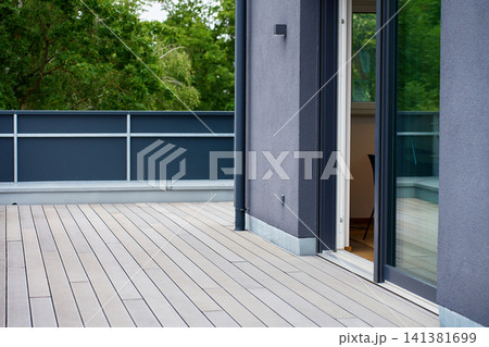 Open Sliding Glass Door Leading to Modern Terrace 141381699