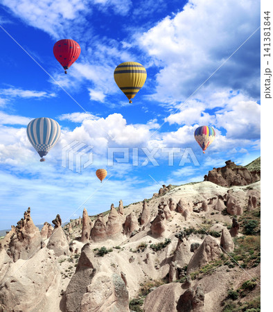 Balloon flight, famous tourist attraction of Cappadocia. Air balloons and Fairy Chimney in Pasabag Valley, Anatolia, Turkey. Topic of vacation, travel, trip abroad on vacation, cruises and tours Balloon flight, famous tourist attraction of Cappadocia. Air balloons and Fairy Chimney in Pasabag Valley, Anatolia, Turkey. Topic of vacation, travel, trip abroad on vacation, cruises and tours 141381844