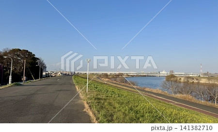 Long paved path beside a broad urban river Long paved path beside a broad urban river 141382710