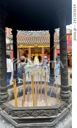 Ornate incense burner inside a traditional temple courtyard Ornate incense burner inside a traditional temple courtyard 141383034