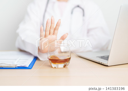 Doctor hand stop to refuse Whisky, quitting drink for healthy liver, prevent Alcoholic cirrhosis and cancer, World No Alcohol Day, medical advice for sobriety and Alcoholism and addiction concept 141383196