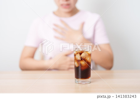 Woman hold stomach and feeling Abdominal pain after drinking carbonated soft drink, bloating and gas in digestive system, unhealthy beverage effect. stomach ache,  Acid reflux, Heartburn and Gastritis 141383243