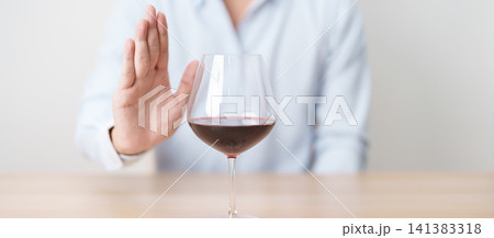man making stop hand gesture to refuse a glass of Wine, Healthy man say no to alcohol drink, stop alcoholism and addiction concept. Responsible man reject a drink before driving and quit booze man making stop hand gesture to refuse a glass of Wine, Healthy man say no to alcohol drink, stop alcoholism and addiction concept. Responsible man reject a drink before driving and quit booze 141383318