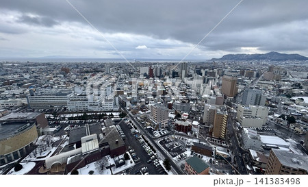 Wide urban landscape stretching toward distant mountains Wide urban landscape stretching toward distant mountains 141383498