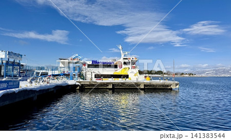 Passenger ferry docked in a bright winter harbor Passenger ferry docked in a bright winter harbor 141383544