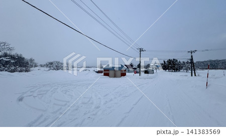 Wide winter recreation field blanketed in fresh snow 141383569
