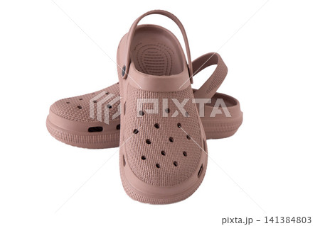 Pair of dusty rose rubber clogs isolated on white background Pair of dusty rose rubber clogs isolated on white background 141384803