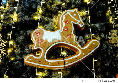 Gingerbread rocking horse ornament on Christmas tree 141385326