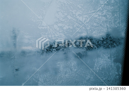 Beautiful frost patterns on a car window in winter Beautiful frost patterns on a car window in winter 141385360