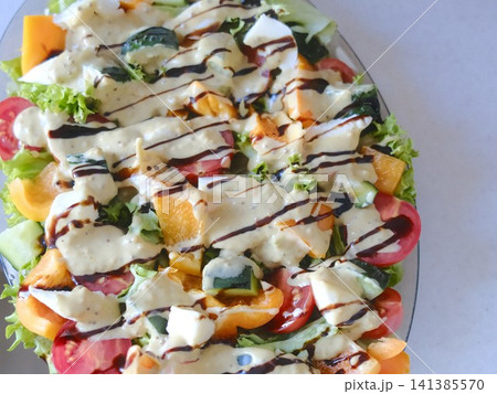 Colorful garden salad with creamy and balsamic glaze 141385570