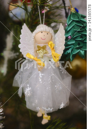 Handmade felt angel ornament with yellow ribbons and gold star for Christmas tree Handmade felt angel ornament with yellow ribbons and gold star for Christmas tree 141385578