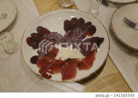 Flat lay of deli selection including salami and cured meat. Perfect for restaurant menu or food blog Flat lay of deli selection including salami and cured meat. Perfect for restaurant menu or food blog 141385593