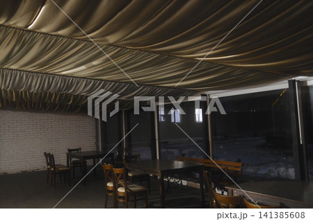 Empty dining area with gold fabric ceiling at night Empty dining area with gold fabric ceiling at night 141385608