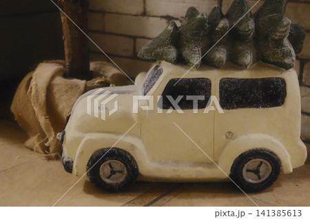 Snowy miniature car transports Christmas trees 141385613
