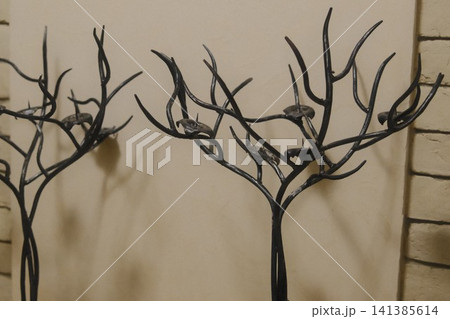Dark wrought iron tree branch candle holders indoors 141385614