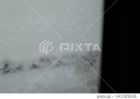 Frosty car windshield on a cold winter day Frosty car windshield on a cold winter day 141385626