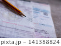 Electricity bill with expense records showing household costs income planning and financial balance. 141388824