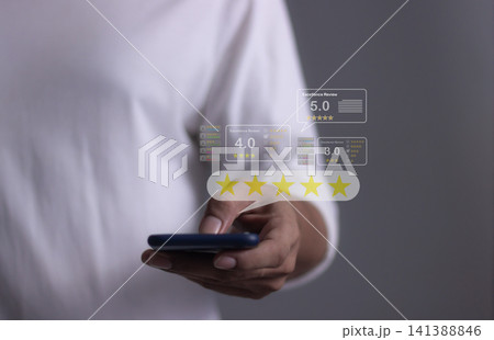 Customer Review, Young Man hand holding Smart Phone with five star to review and give 5 stars Customer Review, Young Man hand holding Smart Phone with five star to review and give 5 stars 141388846