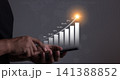 Young man using smartphone to visualize money growth  141388852