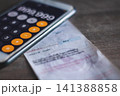 Electricity bill with expense records showing household costs income planning and financial balance. 141388858