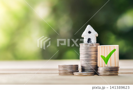 Mortgage and loan approved concept: house on a coin pile. planning savings money of coins to buy a home concept for property ladder, mortgage and real estate invest. Mortgage and loan approved concept: house on a coin pile. planning savings money of coins to buy a home concept for property ladder, mortgage and real estate invest. 141389623