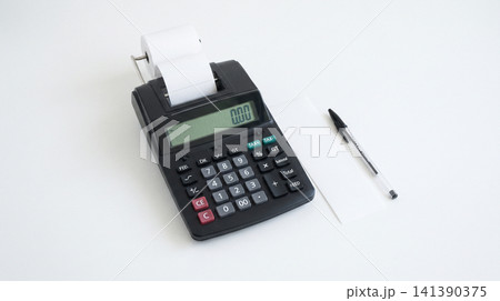 Black desktop calculator with printing paper roll and ballpoint pen on white background calculator stationery accounting business supplies background financial calculation counting equipment Black desktop calculator with printing paper roll and ballpoint pen on white background calculator stationery accounting business supplies background financial calculation counting equipment 141390375