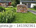 Woodpile of Birch Firewood on Lawn in Porvoo, Finland. 141392361